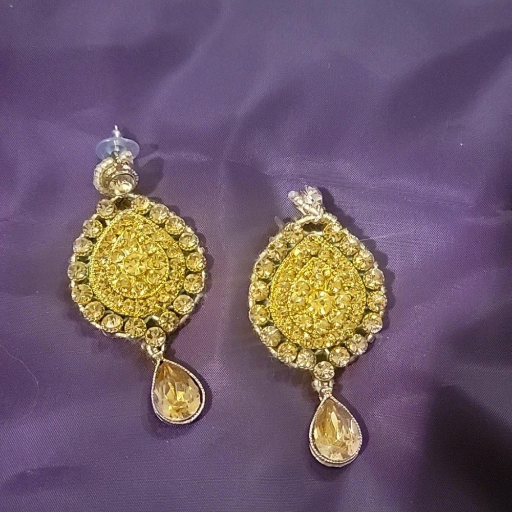 Gold Tone Crystal Teardrop Earrings base metal is alloy and yellow rhinestones